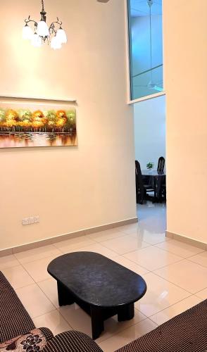 a black coffee table in a room with a window at Cozy Homestay in Ipoh