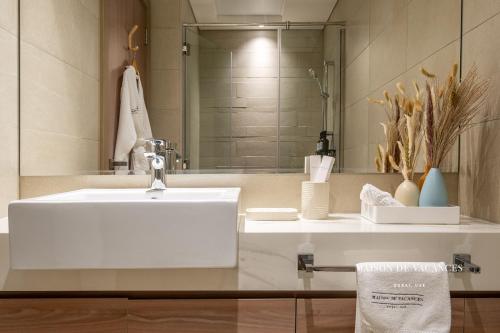 a bathroom with a white sink and a mirror at Santorini Studio Pool View in Dubai