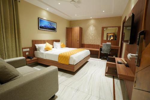 a hotel room with a bed and a couch at Hotel Valley Vista in Visakhapatnam