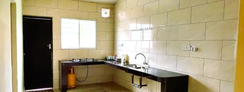 a large bathroom with a sink and a window at Cozy Homestay in Ipoh
