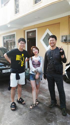 a group of three people standing in front of a house at Mount View Bungalow in Hatton