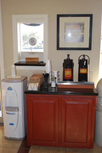 a kitchen with a counter top with a washer and a dryer at Americas Best Value Inn Lubbock East in Lubbock