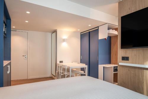 a hotel room with a bed and a television at Holiday Inn Express & Suites Ghent by IHG in Ghent