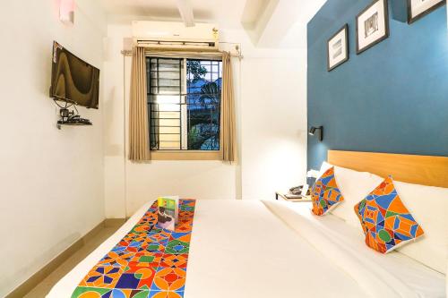 a bedroom with a bed and a window at FabHotel Azure Sky - Nr Ruby Hospital in Kolkata