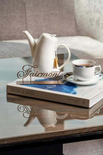 a book and a tea pot and a cup on a table at Fairmont Chengdu in Chengdu