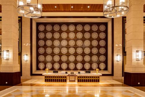a lobby with a large wall in the middle at The Danna Langkawi - A Member of Small Luxury Hotels of the World in Pantai Kok