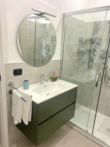 a bathroom with a sink and a shower with a mirror at Casa Grazia in Domodossola