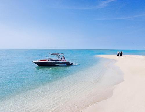 a boat in the water on a beach at Miyakojima Kurima Resort Seawood Hotel in Miyako Island