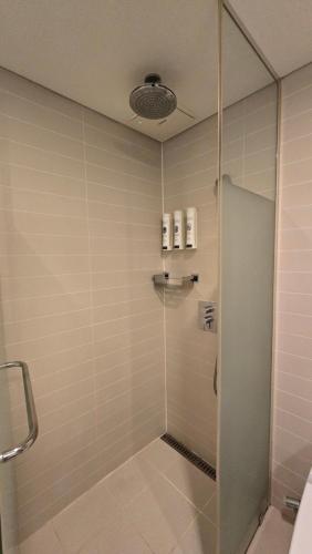 a shower with a glass door in a bathroom at Sotetsu Hotels The Splaisir Seoul Myeongdong in Seoul