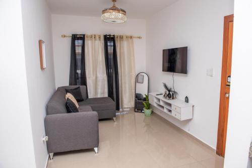 a living room with a couch and a chair at Luxury Aparment Bonao in Bonao
