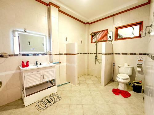 une salle de bain avec des toilettes blanches et un lavabo dans l'établissement Amara Beach Resort Koh Phangan, à Haad Yao