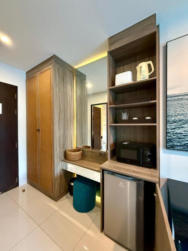 a kitchen with a counter and a sink and a microwave at Deluxe Twin Bed Apartment by Renttini in Kamala Beach