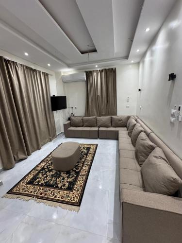 a living room with a large couch and a table at PiPi NUBIAN HOUSE in Aswan