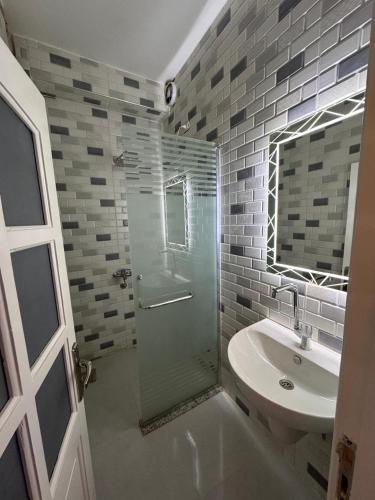 a bathroom with a glass shower and a sink at PiPi NUBIAN HOUSE in Aswan