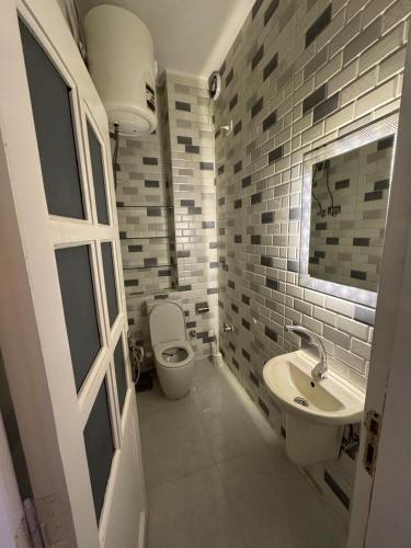 a bathroom with a toilet and a sink at PiPi NUBIAN HOUSE in Aswan