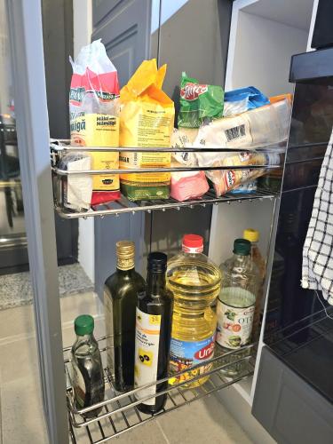 a refrigerator shelf filled with food and drinks at Marianne, Apartament 2 Camere, Morii Lake 2 in Bucharest