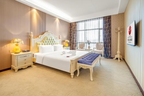 Postel nebo postele na pokoji v ubytování Zhangzhou Yuyuan Hotel