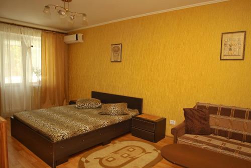 a bedroom with a bed and a couch at Comfortable Apartments in Kryvyi Rih