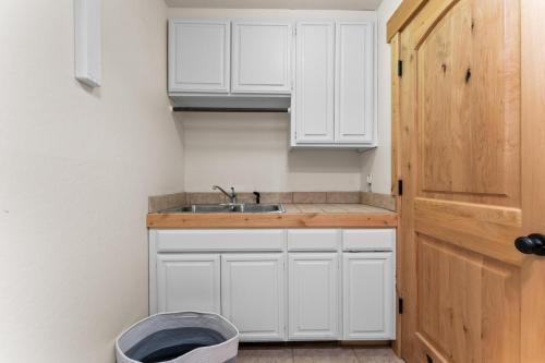 a kitchen with white cabinets and a sink at Luxury Lakeview Retreat - Hot Tub, SUP, Sauna & More! in Carnelian Bay