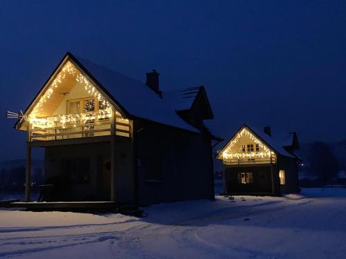 a house with christmas lights on it at night at Ciche Pole in Maniowy