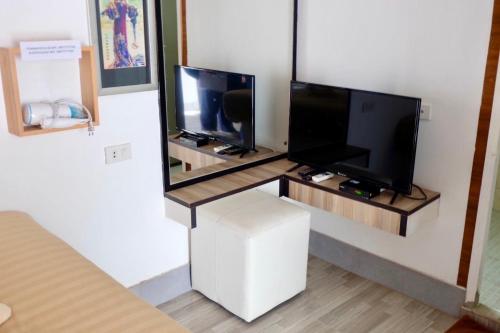 a room with a flat screen tv on a wall at The Resort Angel Hill in Ban Khlong Phai