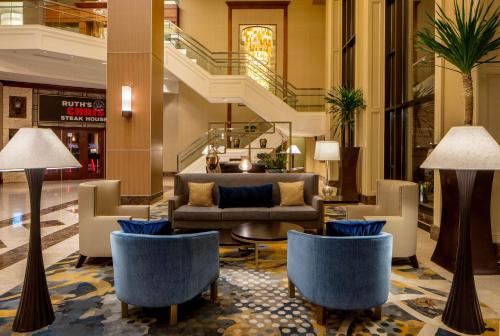 a lobby with couches and chairs in a building at Hyatt Regency Saint Louis at The Arch in Saint Louis