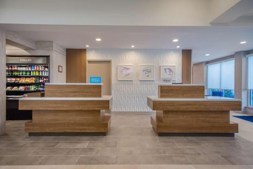 a lobby of a library with wooden counters and a book shelf at Hilton Garden Inn Danbury in Danbury