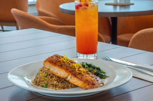 a plate of food and a drink on a table at Hilton Garden Inn Danbury in Danbury