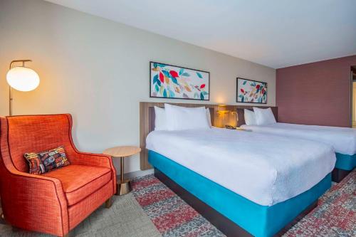 a hotel room with a bed and a chair at Hilton Garden Inn Danbury in Danbury