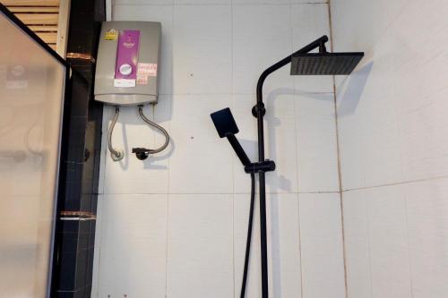 a shower in a room with a phone on the wall at The Resort Angel Hill in Ban Khlong Phai