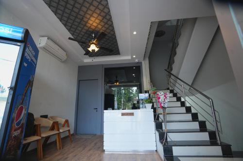 a staircase in a building with a stair case at Hotel Vardhaman Inn in Yavatmāl