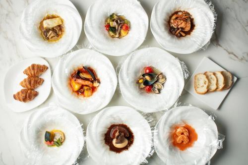 a bunch of plates of food on a table at Nagoya Kanko Hotel in Nagoya