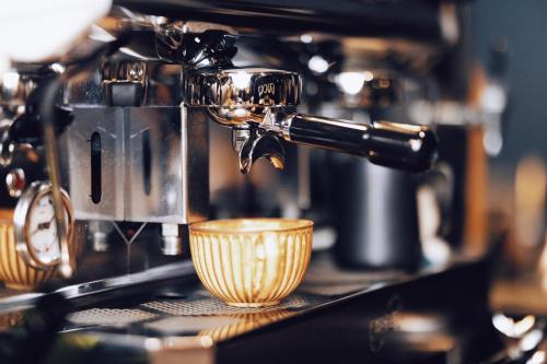 a espresso machine is making a cup on a counter at 深圳看见海海景精品民宿 in Shenzhen
