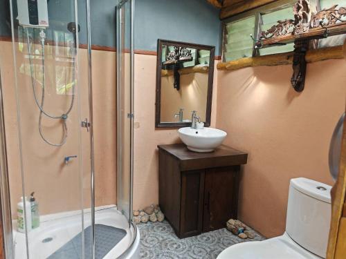 a bathroom with a shower and a sink and a toilet at ธารทอง ลอดจ์ Tharnthong Lodge in Ban Pang Champi