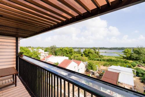 a balcony with a view of the water at Ancient River Villa in Hoi An