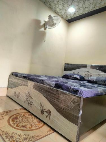 a large bed in a room with a ceiling at Shanti Paying Guest House in Mathura
