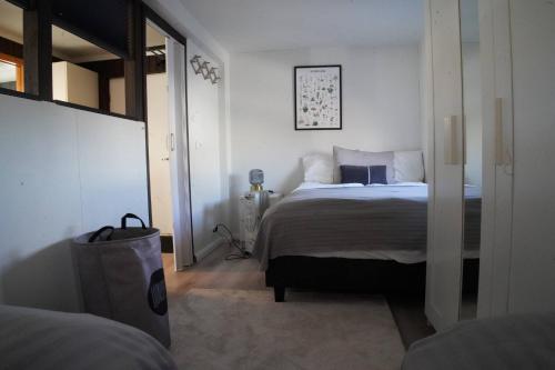 a bedroom with a large bed in a white room at Hlakot Cabin In Golden Circle in Mosfellsbær