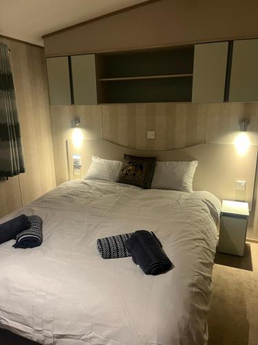 a large white bed with two pillows on it at Gorsehill 44 in Lytchett Minster
