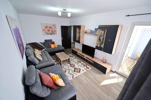 a living room with two couches and a flat screen tv at FLH - The Happy Nest - a child-friendly apartment in Sibiu