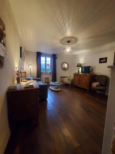 a living room with a couch and a table at Chez Émile maison d'hotes 2 chambres avec jardin privé in Humes