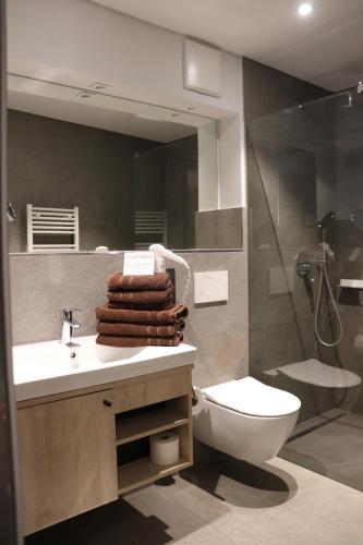 a bathroom with a sink and a toilet and a mirror at Alte Molke in Meersburg