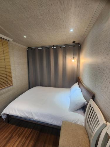 a small bedroom with a bed and a couch at Suyu Station Motel in Seoul