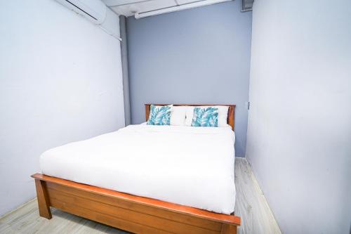 a small bedroom with a bed in a room at Swing & Pillows @ Beach Street in George Town