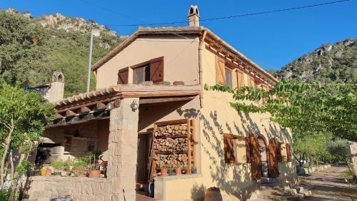 a building with a sign on the side of it at La Calma Montblanc Prenafeta in Prenafeta