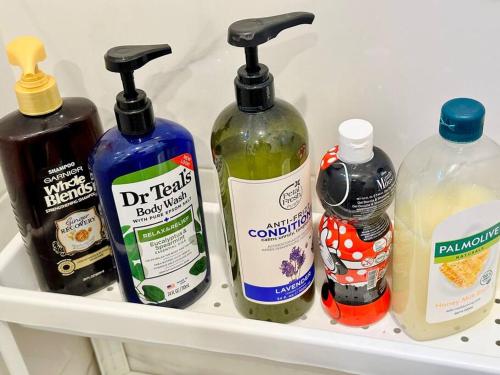 a refrigerator shelf with four bottles of cleaning products at Tiny Hideaway Luna House with free 2 motorbikes in El Nido