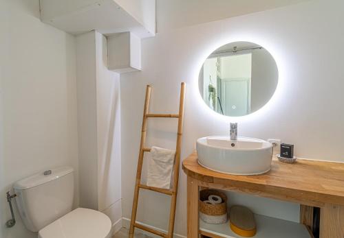 a bathroom with a sink and a toilet and a mirror at Charming Studio In The Heart Of Menton in Menton