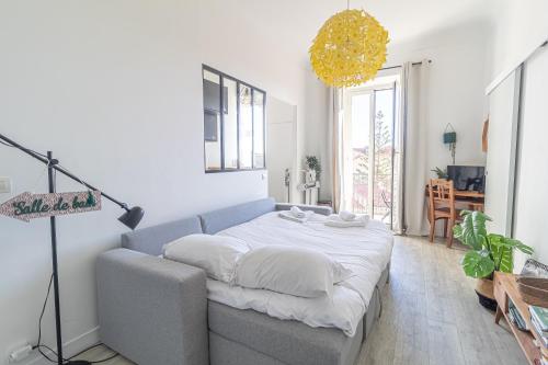 a living room with a couch and a table at Charming Studio In The Heart Of Menton in Menton