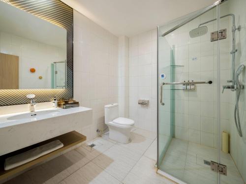a bathroom with a shower and a toilet and a sink at Holiday Inn Express Chengdu Tianfu Square by IHG - Chunxi Road and Kuanzhai Alley in Chengdu