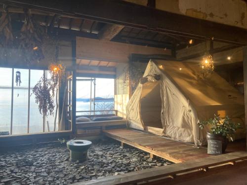 a tent in a room with a view of the water at Lemon tree hotel in Higashiura
