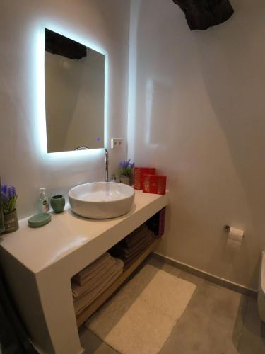a bathroom with a white sink and a mirror at Villa Benjamin in Milatos